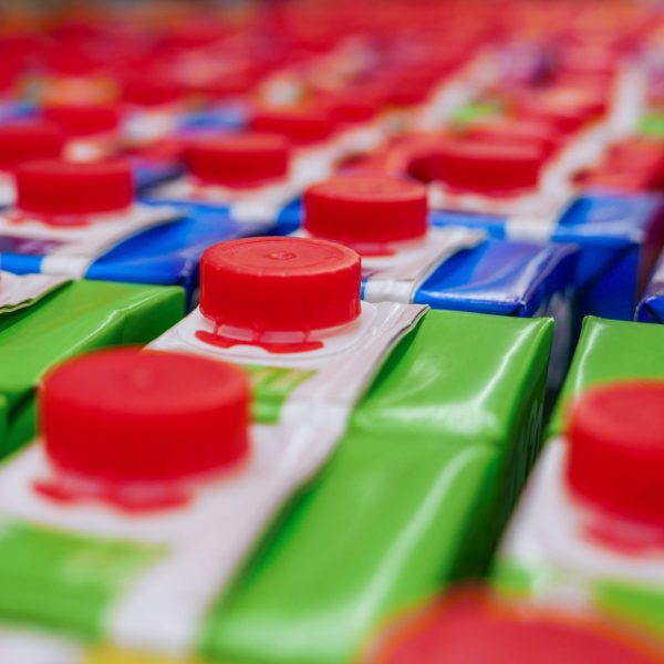 stock-photo-colorful-juice-cartons-with-red-screw-cap-in-supermarket-shelf-668117407